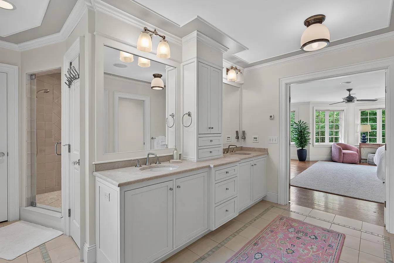 Fitted bathroom vanity and tall built-in cabinet with paneled fronts