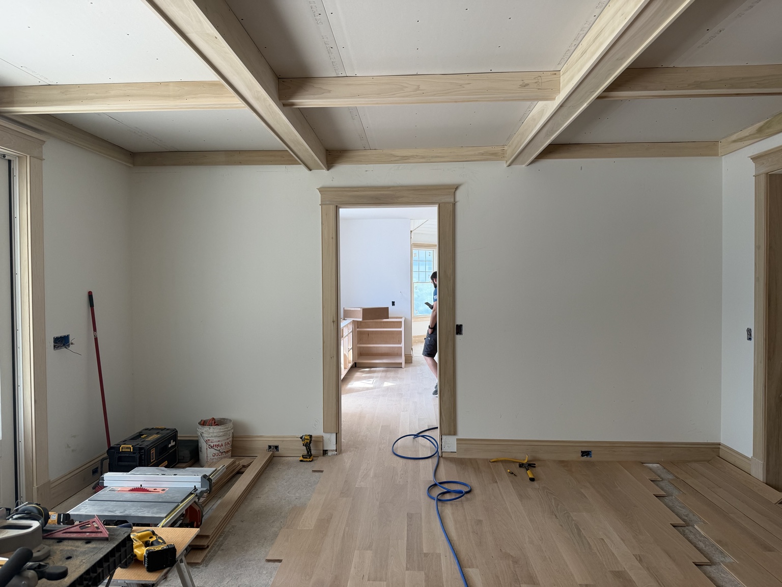 Ceiling trim, door casings and baseboards in a room during finish carpentry