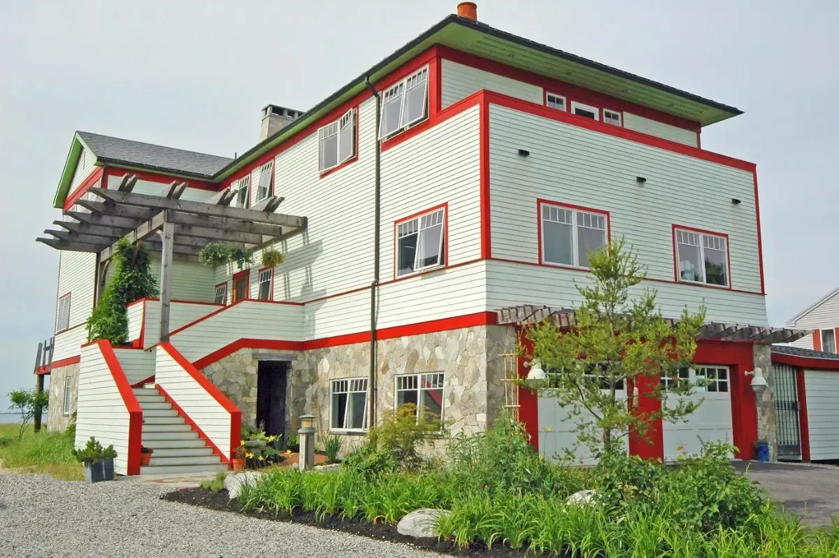 White and red exterior of the Pine Point Beach residence with an outdoor stair