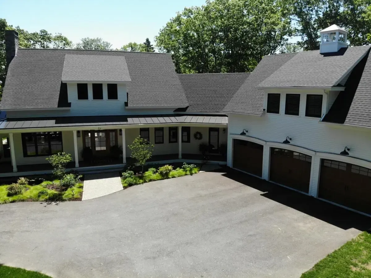 Aerial view of the Cape cottage and its three-car garage