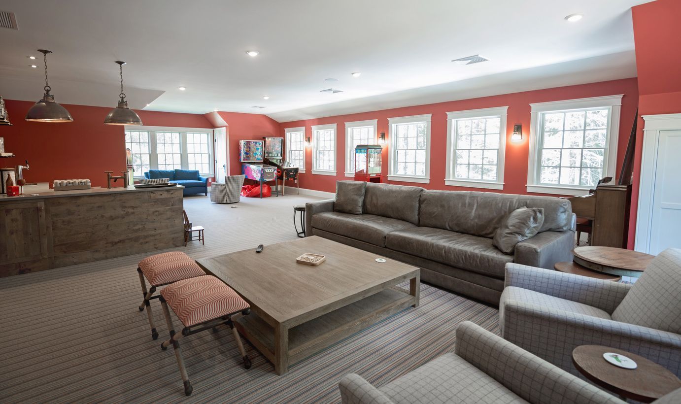 Living room with sofa, chairs, coffee table, and bar