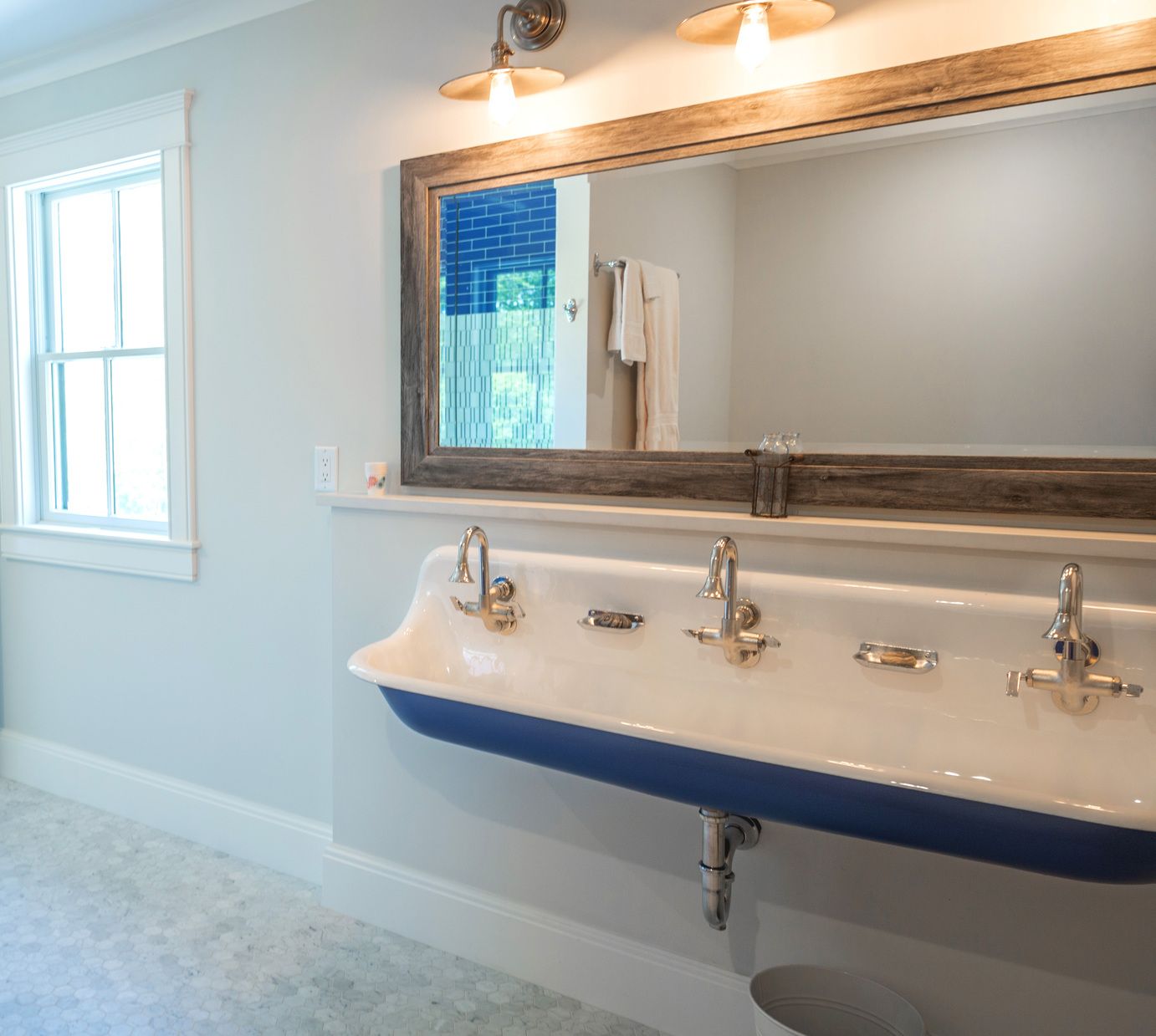 Bathroom with a three-sink vanity and large mirror