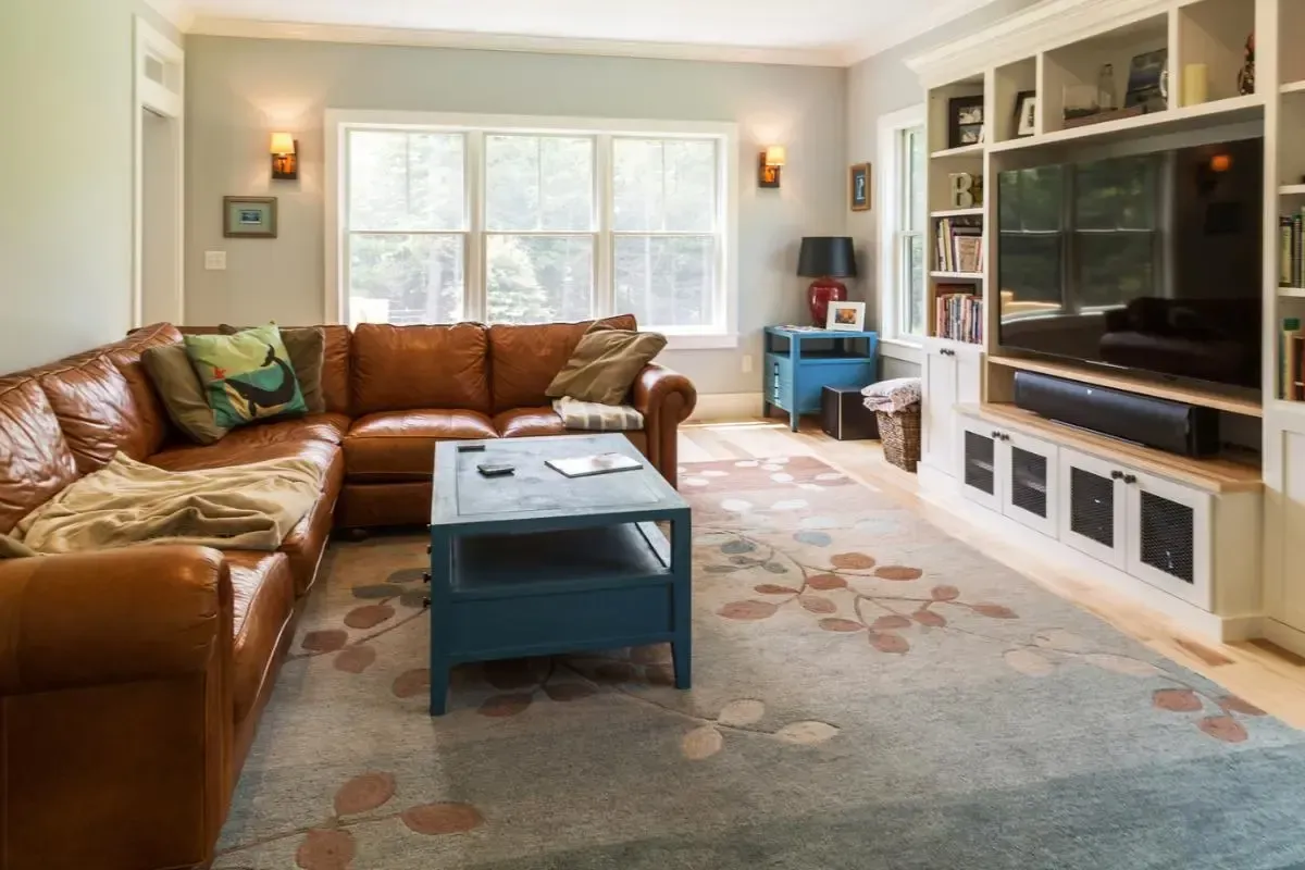 Living room with a brown sectional and blue coffee table