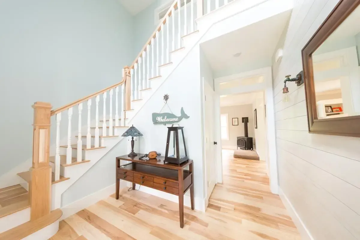 Entry hall with staircase and a welcome sign