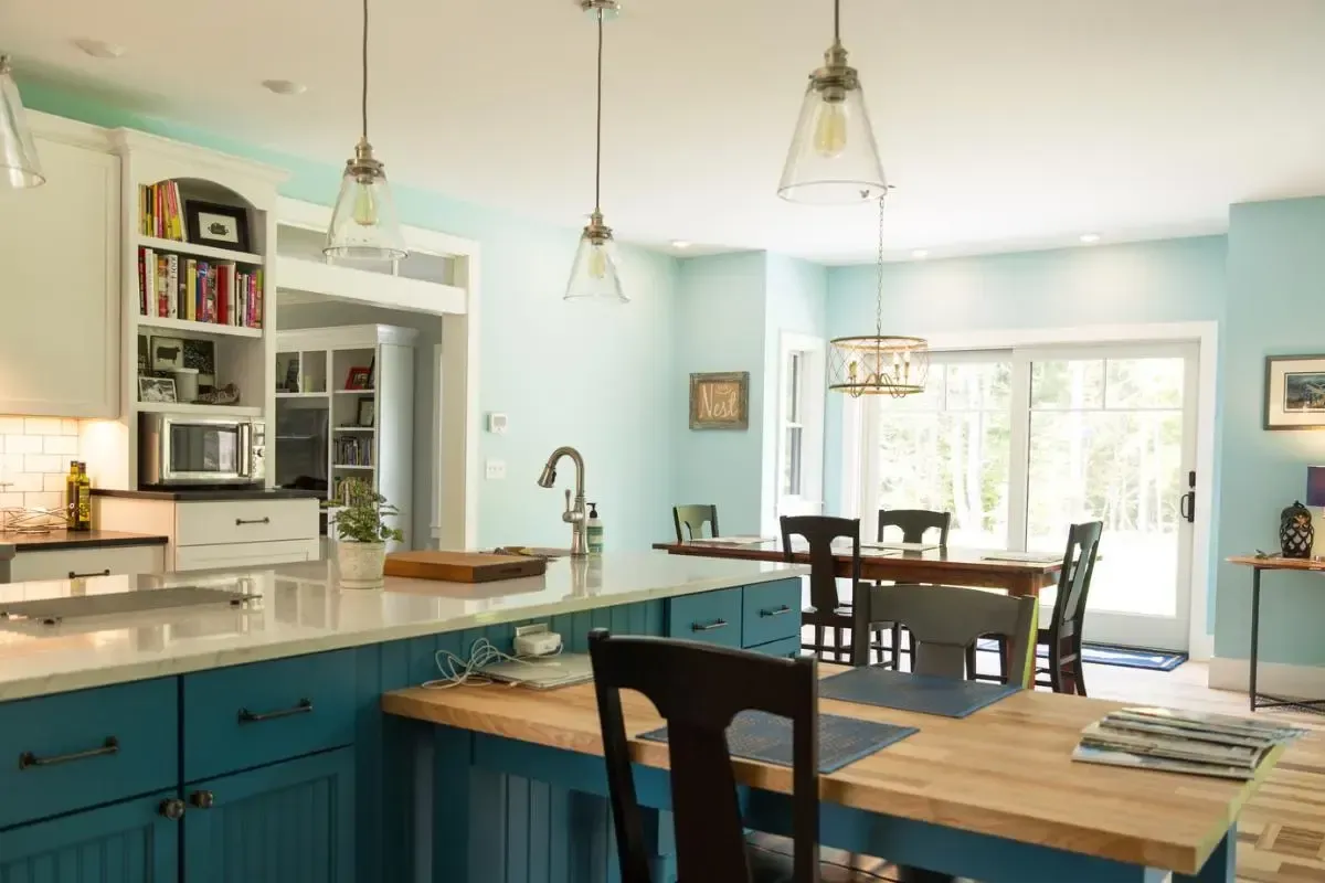 Kitchen with blue cabinetry and a wood dining table