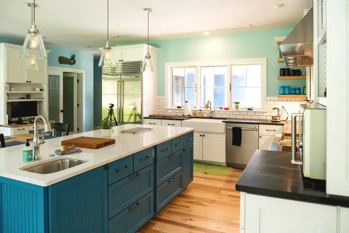Blue kitchen cabinets with white countertops