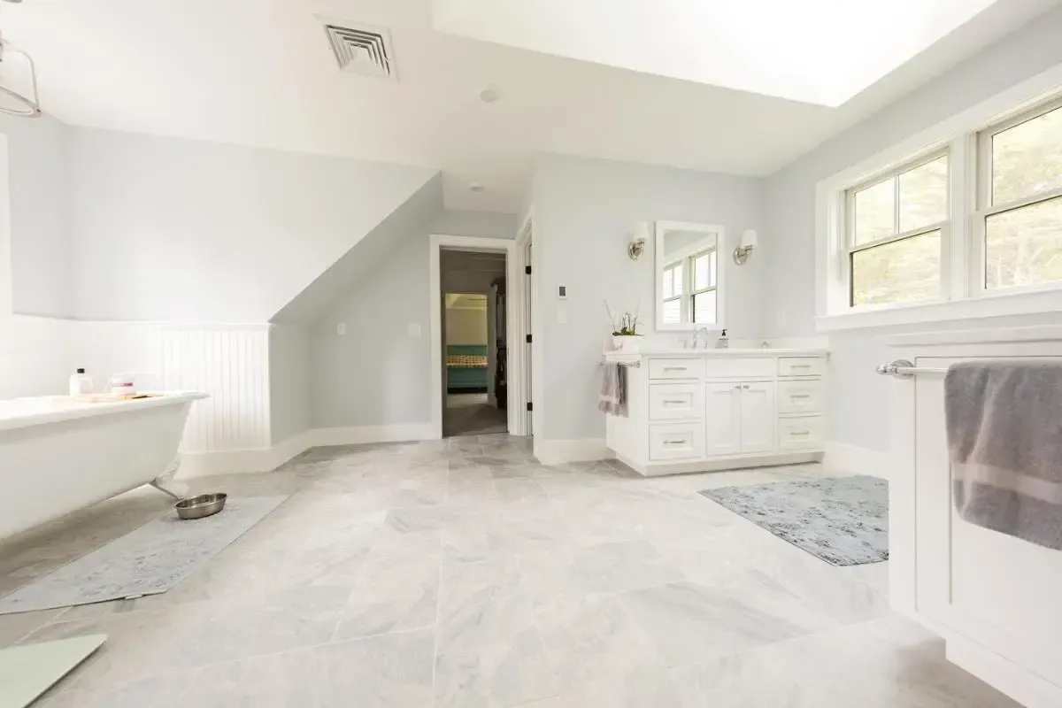 Bathroom with a bathtub, sink, and mirror