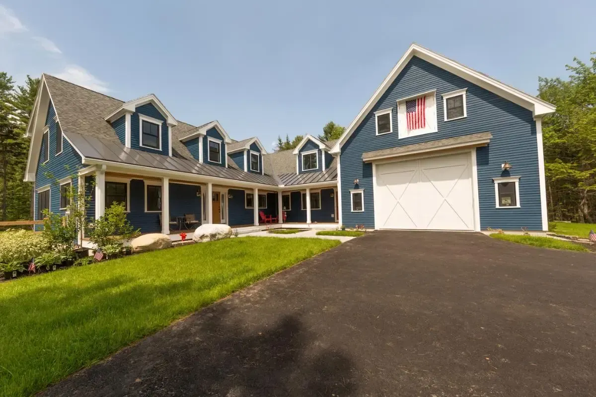 Blue Cape Elizabeth home with garage and covered porch