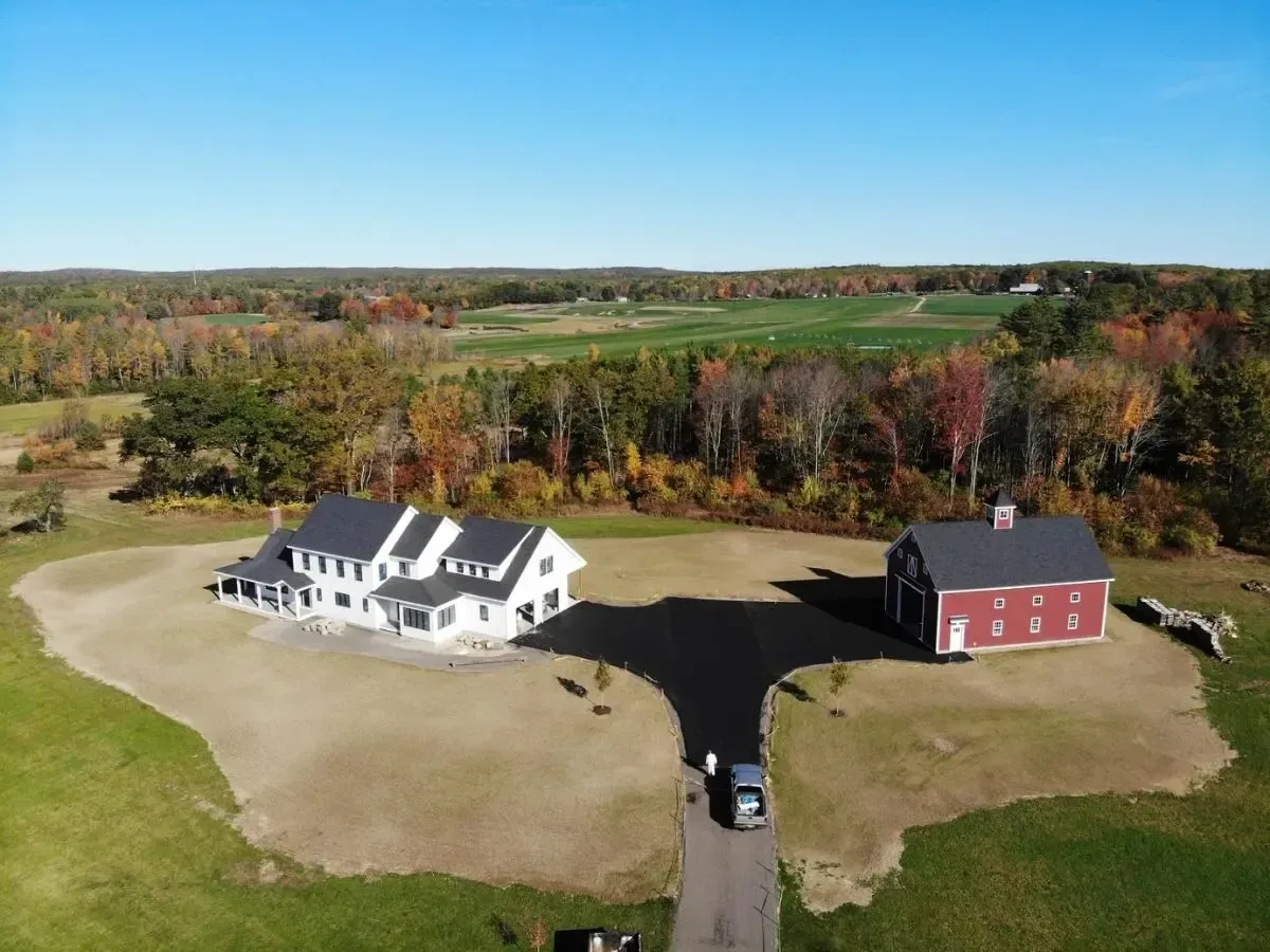 Aerial view of the Lyman Colonial and barn in an open field