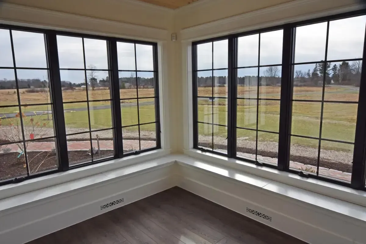 Window-lined room overlooking the surrounding field