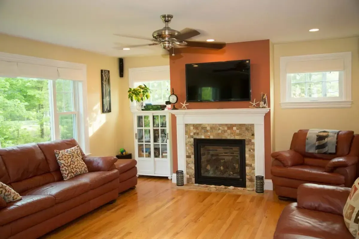 Living room fireplace with a television mounted above