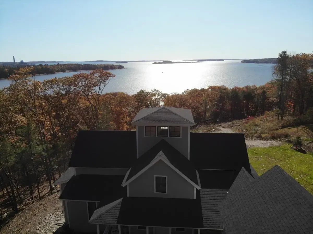 Aerial view of the cottage with the lake beyond