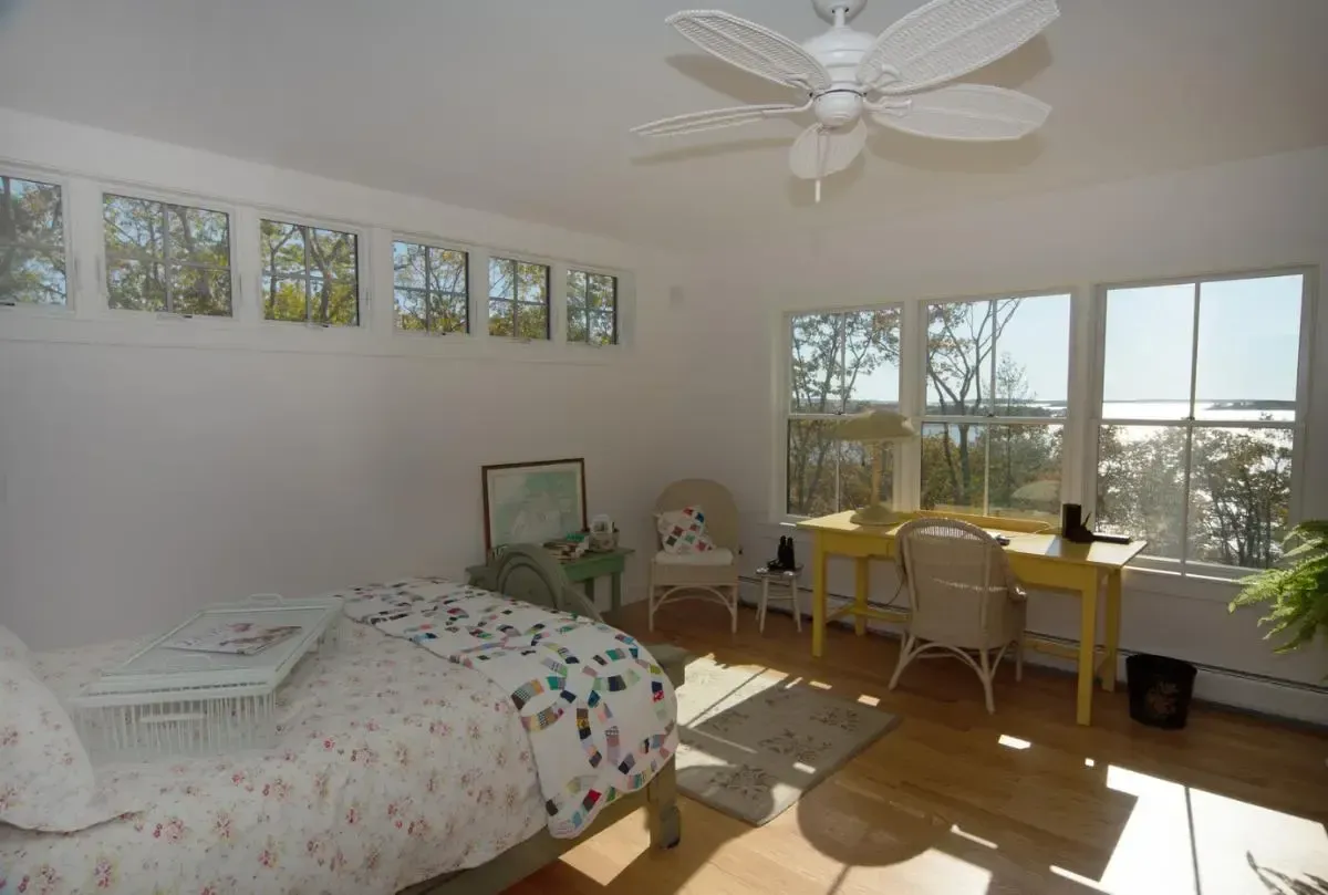 Bedroom with a desk, bed, and ceiling fan
