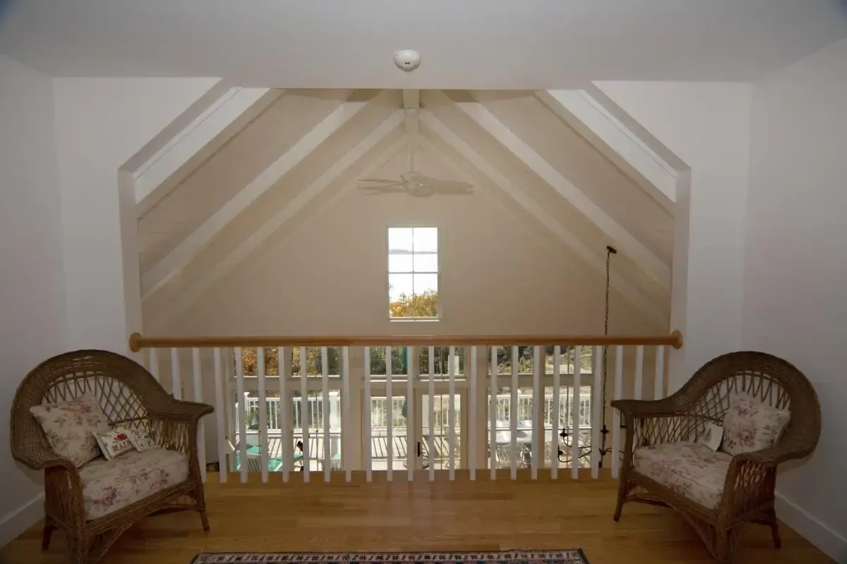 Wicker chairs arranged beside a large window