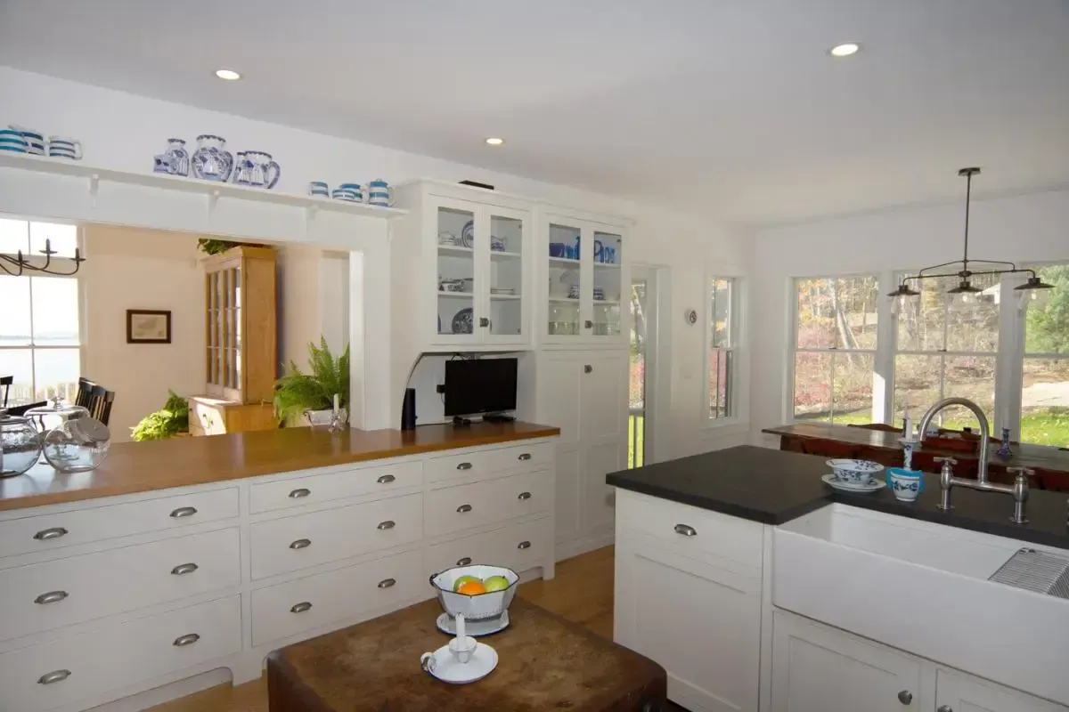 White kitchen cabinets paired with dark countertops