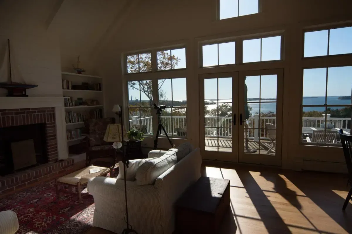 Living room with broad windows overlooking the water