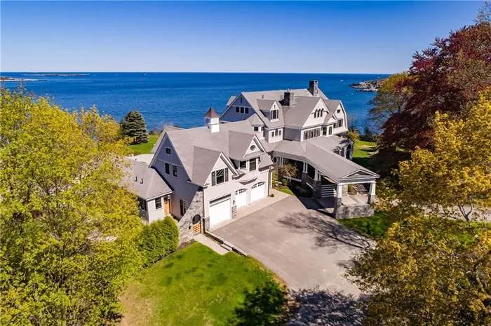 Aerial view of a coastal shingle home near the water