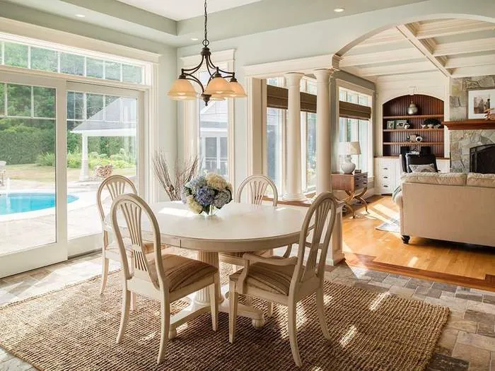 Sunlit dining room with windows and detailed trim