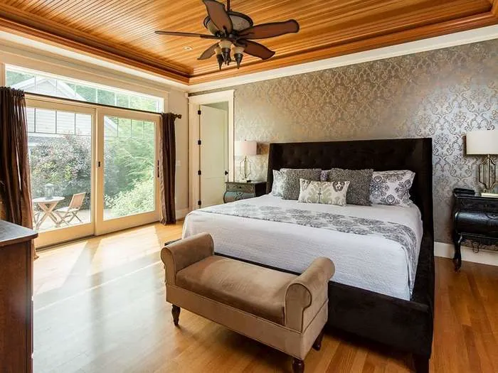 Bedroom with a wood ceiling and tailored finishes
