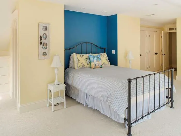 Guest room with blue walls and white trim