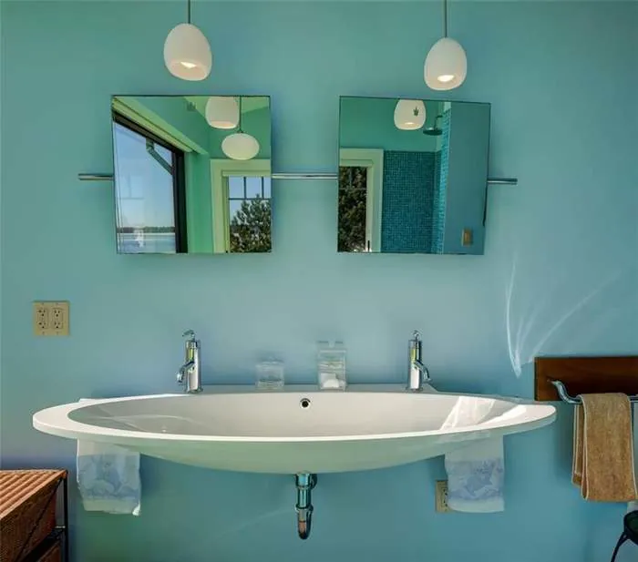 Finished bathroom with a freestanding sink and green tile