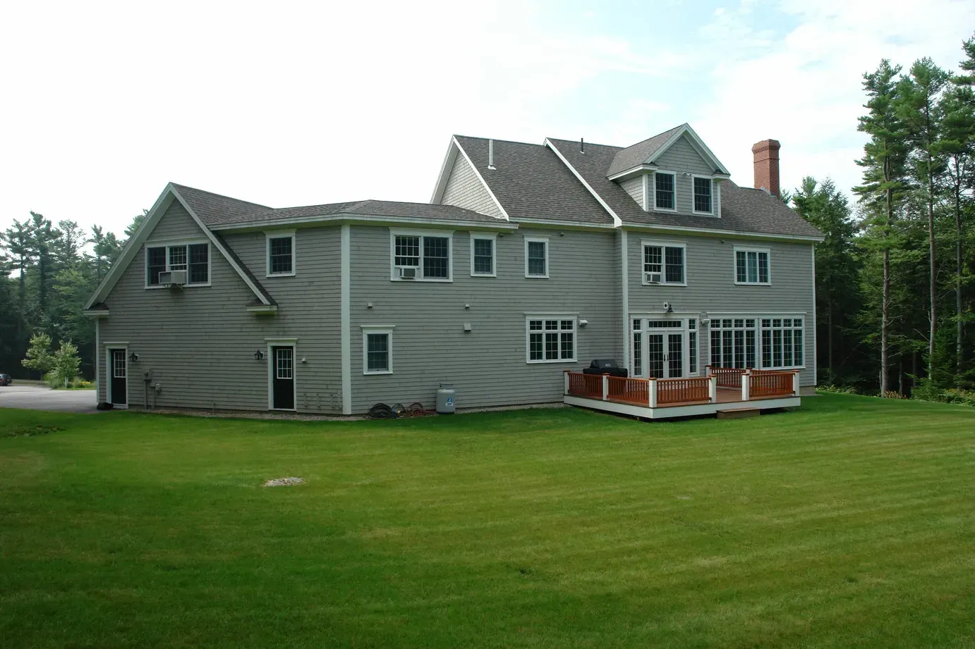 Colonial home set behind a broad front lawn