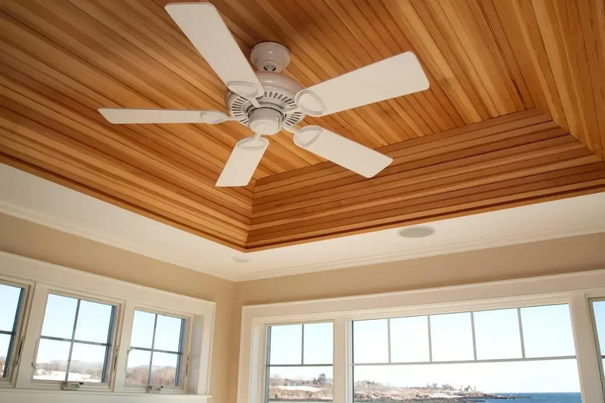 Ceiling fan in a bright room with broad windows