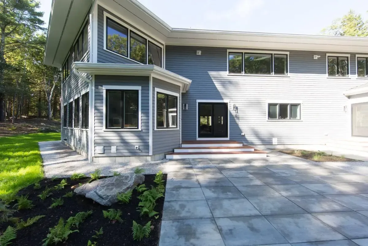 Modern home with broad windows and a front patio