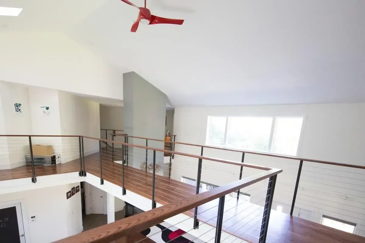 Ceiling fan beneath a high interior ceiling