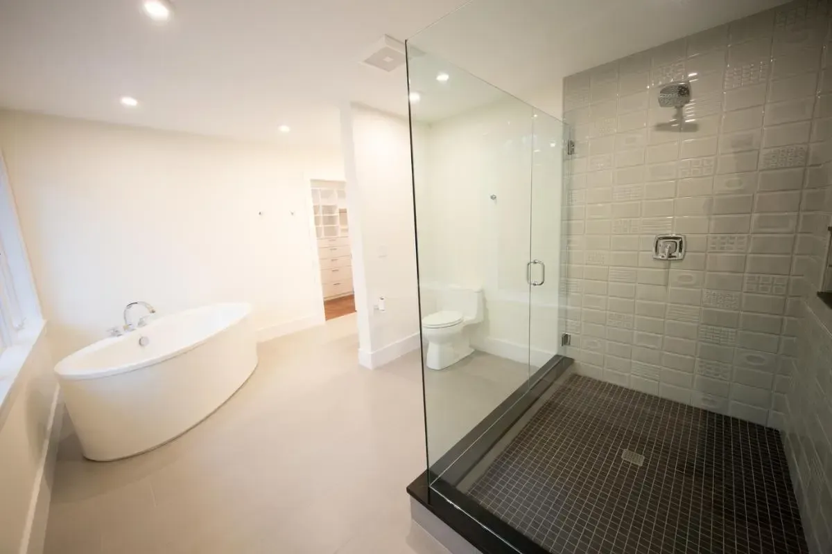 Bathroom with a tub, toilet, and separate walk-in shower