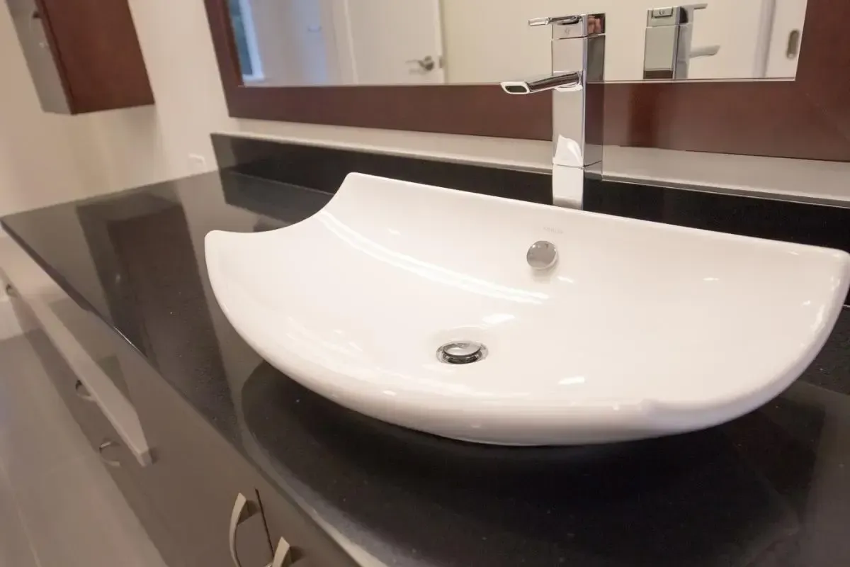 Bathroom vanity with a sink, faucet, and mirror