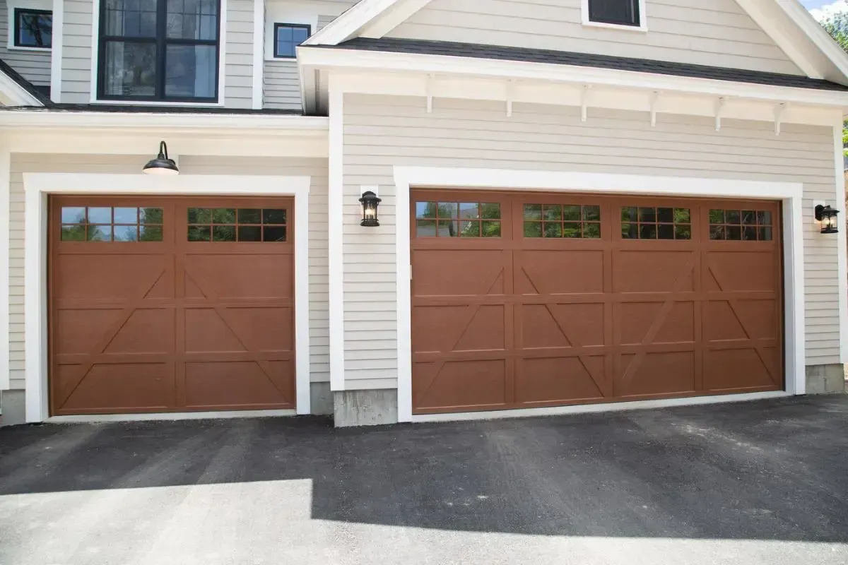 Pair of brown garage doors on the side of the home
