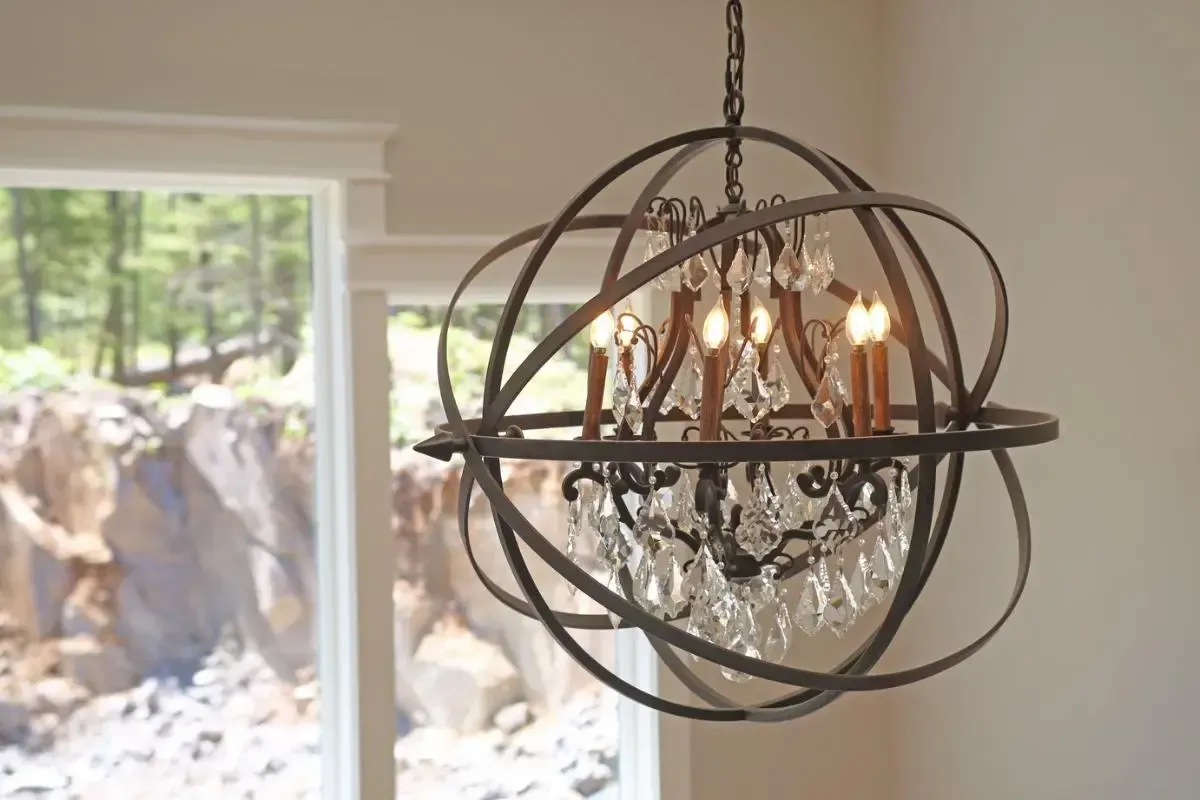 Chandelier suspended in front of a tall window