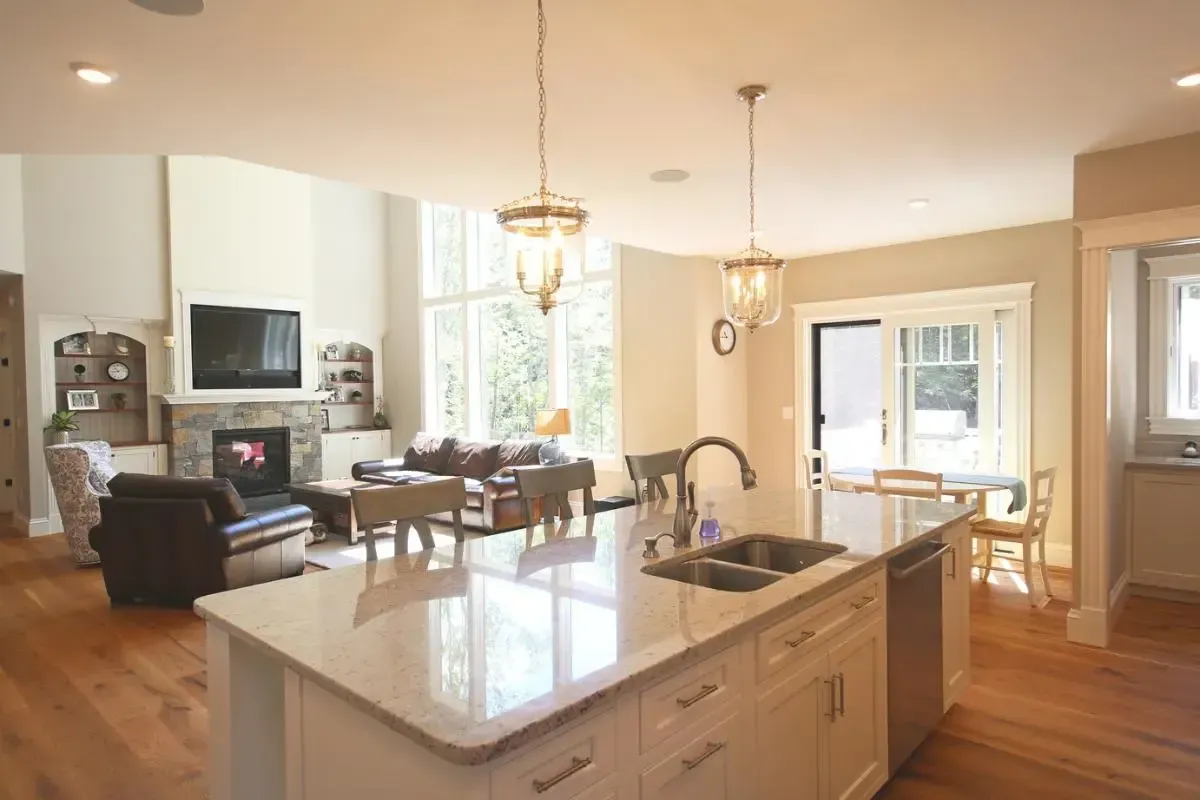 Kitchen sink and cabinetry beside the living-room fireplace
