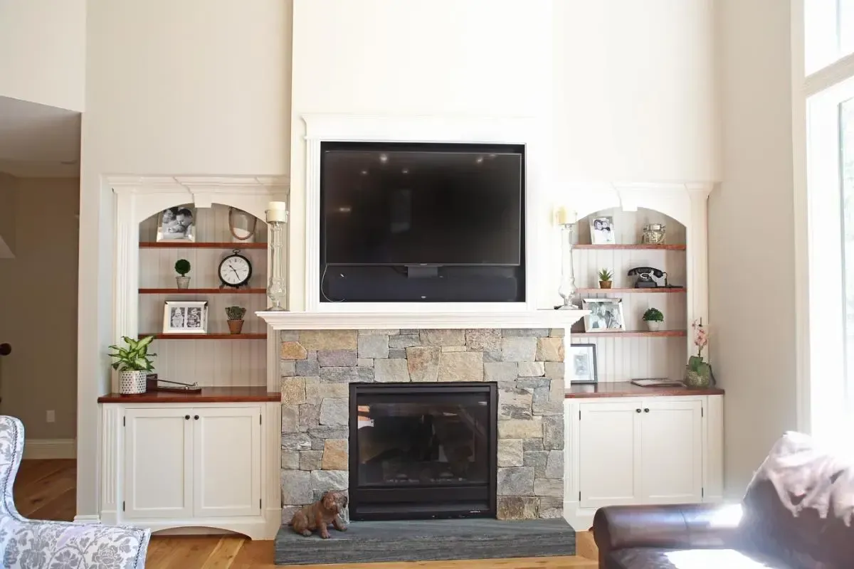 Living room fireplace with a television mounted above