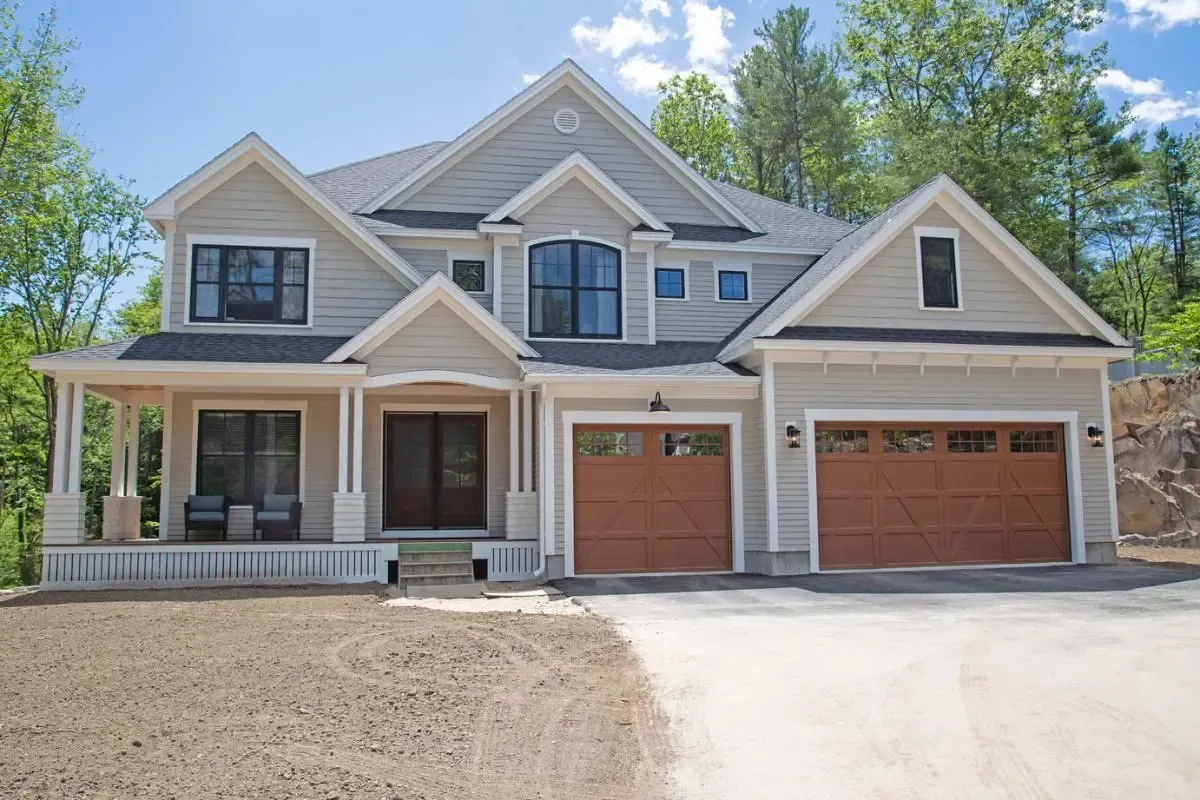 Two-story home with a double garage and covered porch