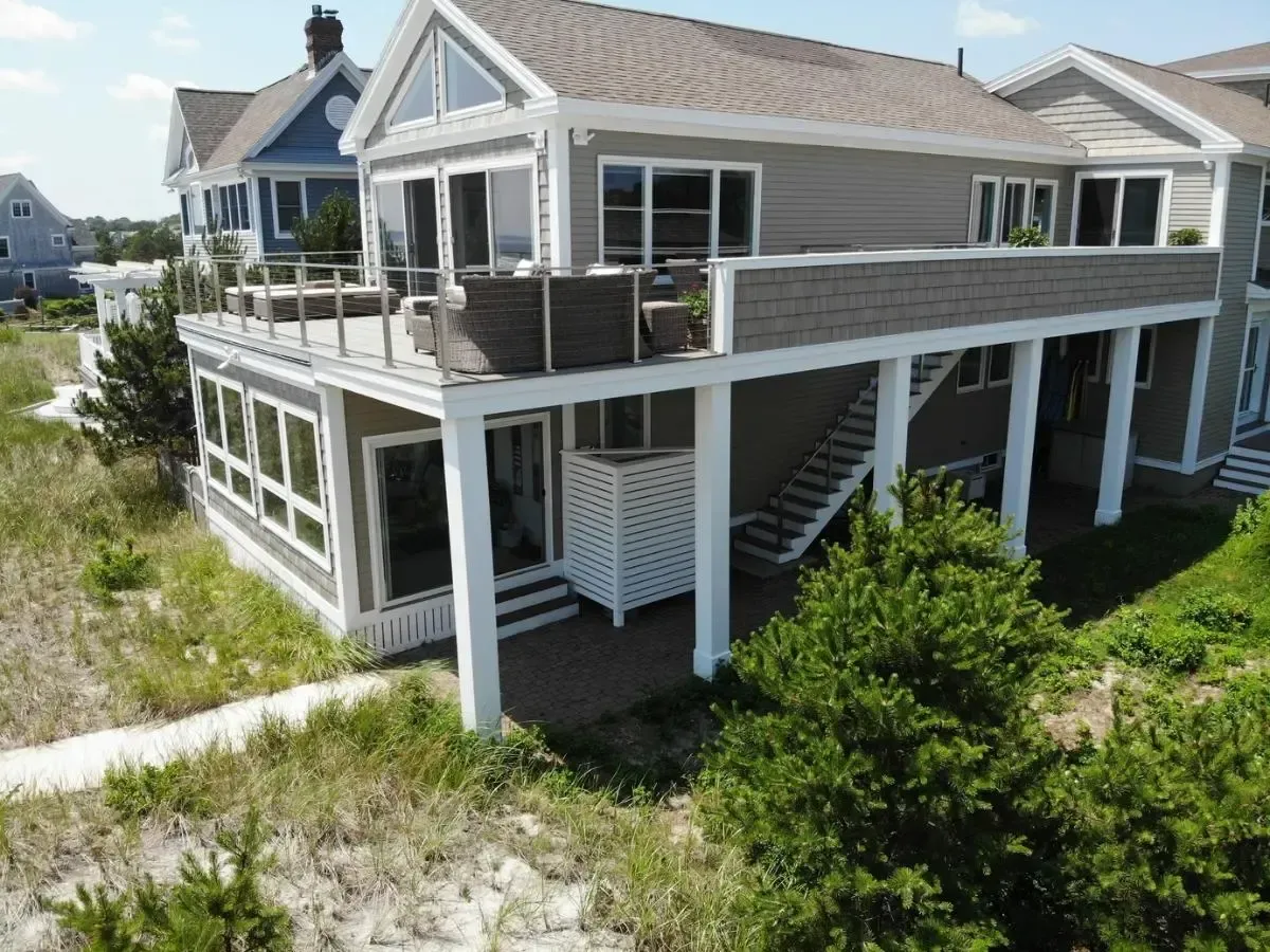Remodeled waterfront home in Ocean Park, Saco, Maine, with an upper-level deck and exterior stairs