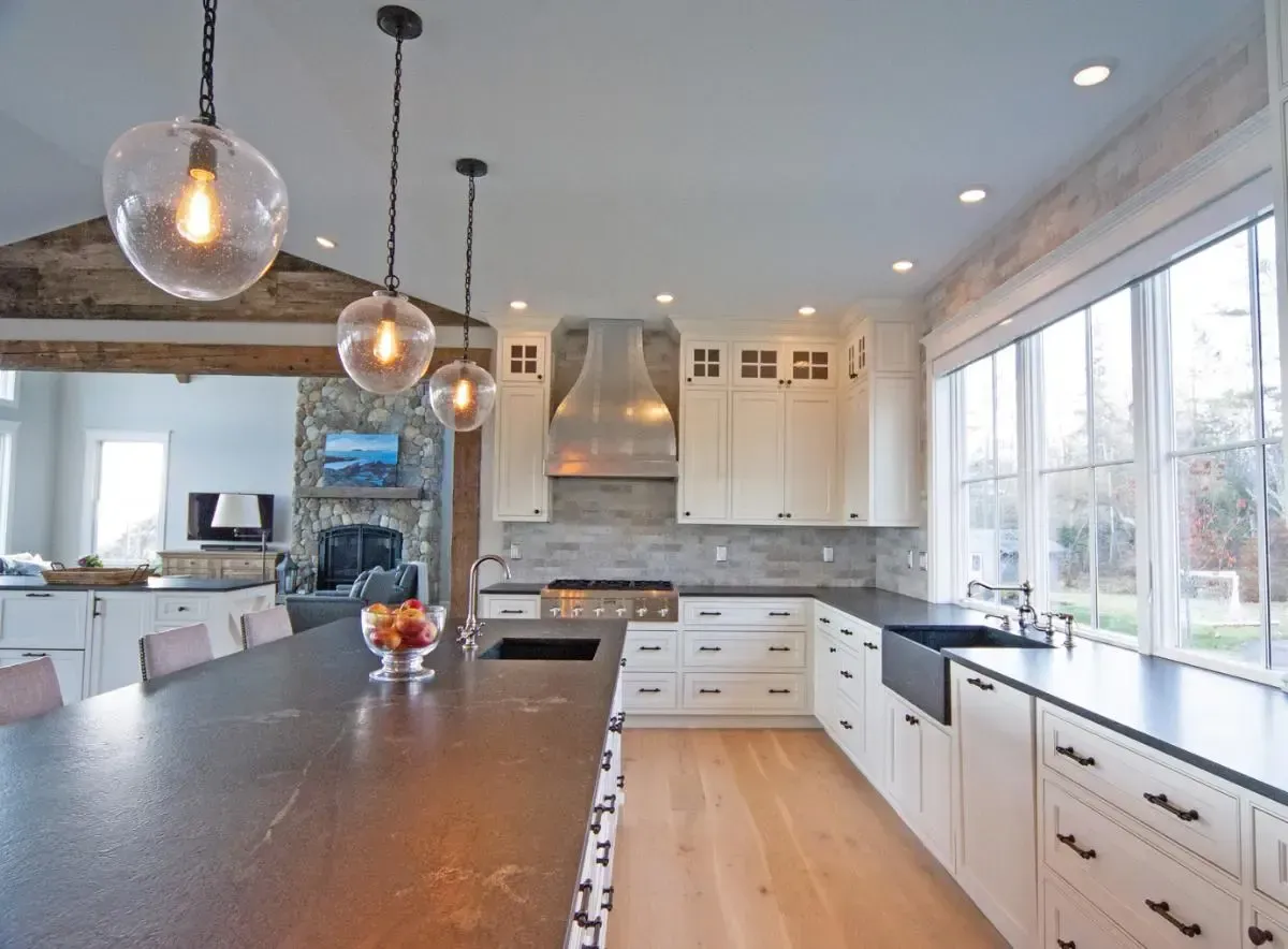 Renovated ranch kitchen with white cabinetry and black countertops