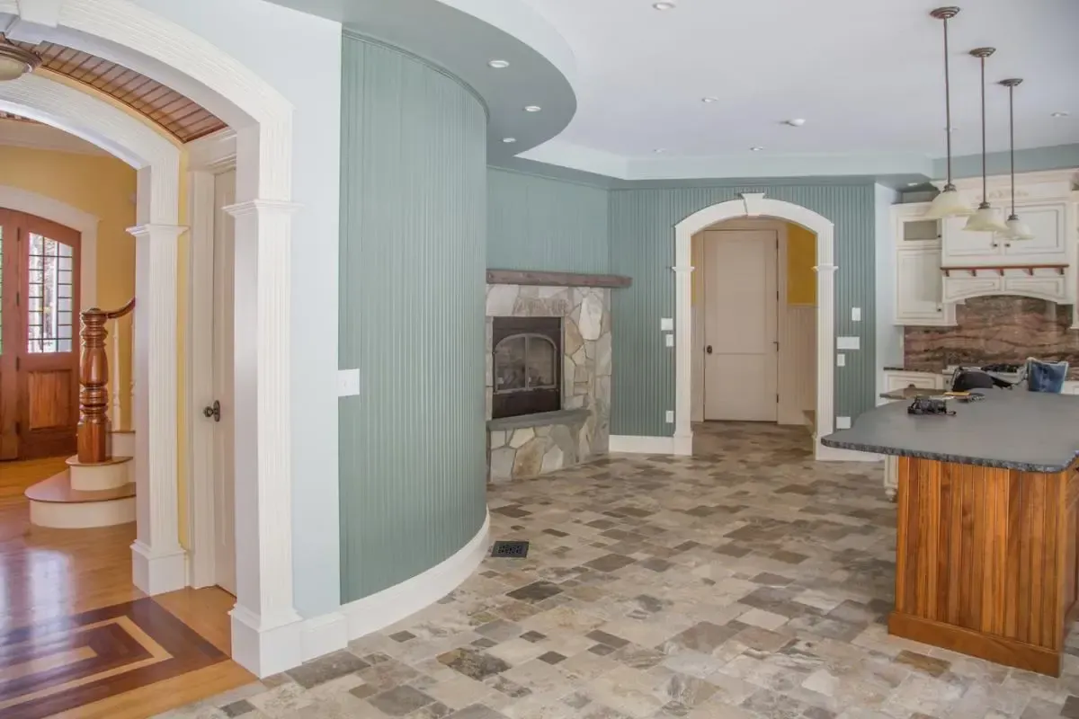 Kitchen with a curved wall and adjacent fireplace