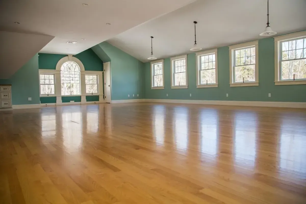 Unfurnished room with green walls and hardwood floors
