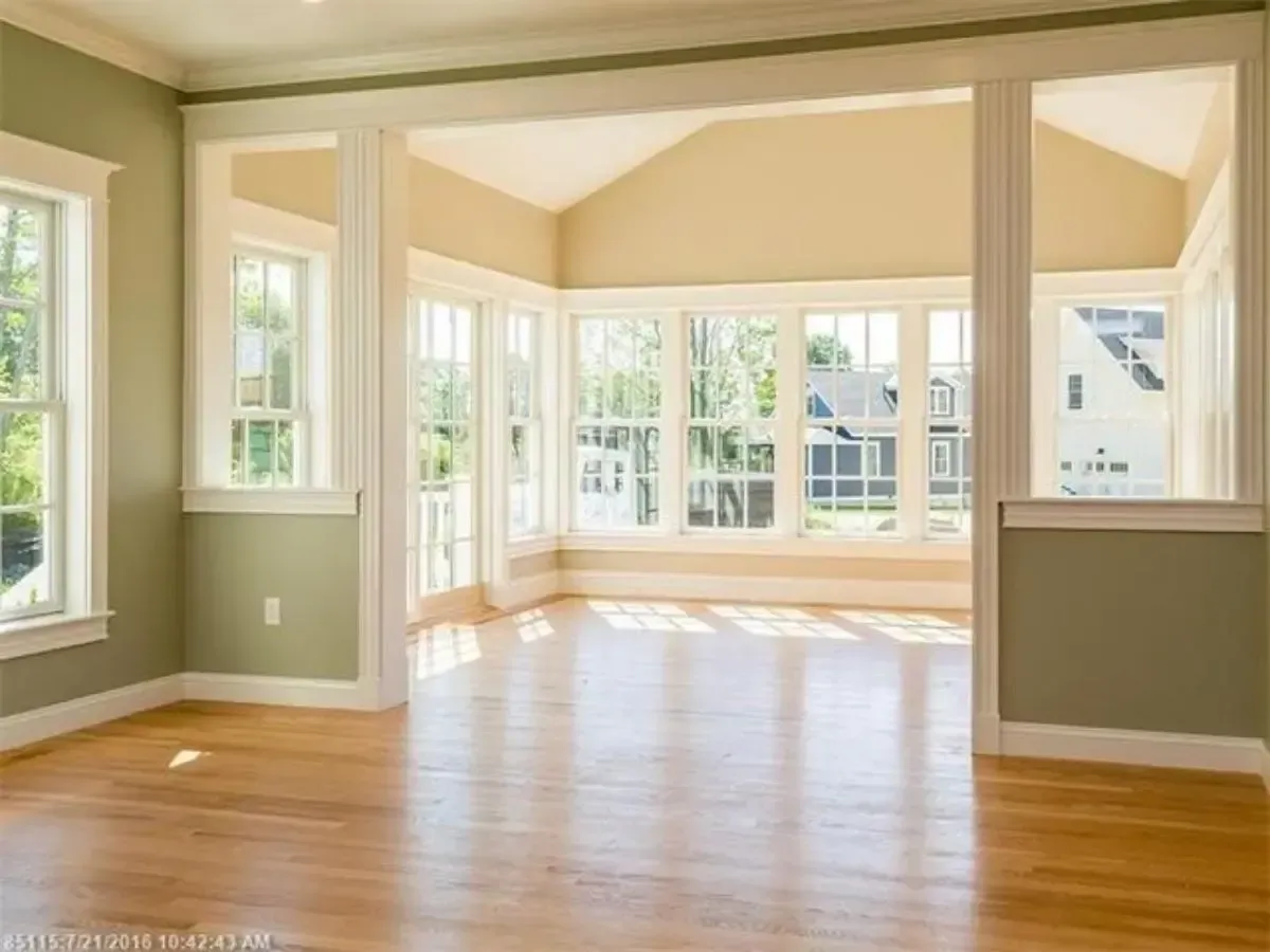 Unfurnished room with hardwood floors and broad windows