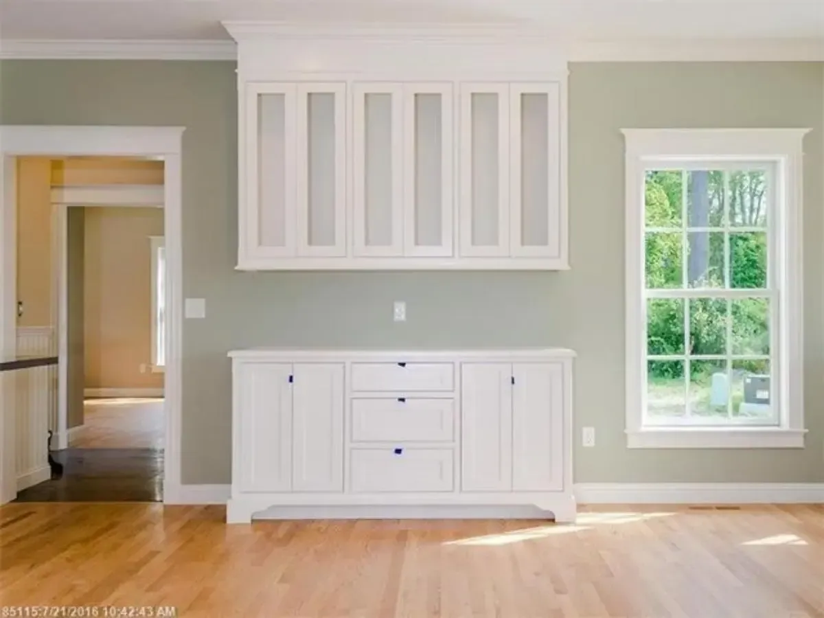 Unfurnished room with white built-in cabinetry and a window