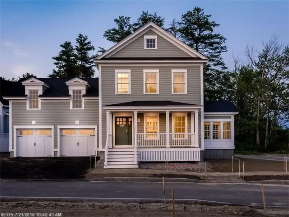 Scarborough home with two garages and a covered porch