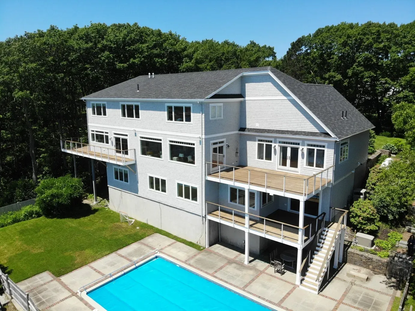 Aerial view of the Falmouth Foreside shingle-style home and swimming pool