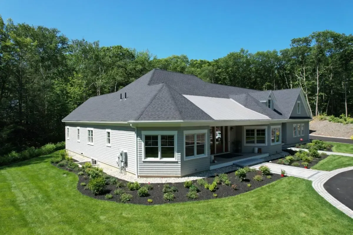 Shore Road residence in Cape Elizabeth, with its gray roof and grounds framed by trees