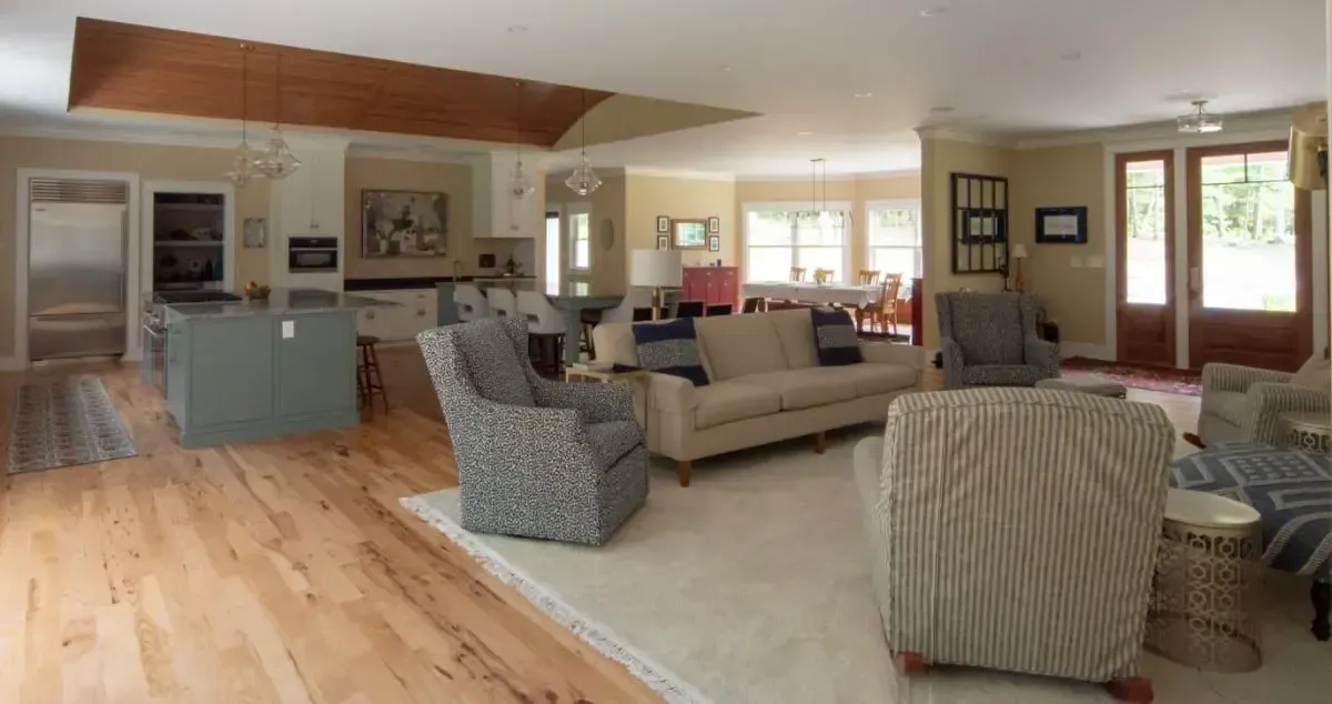 Living room with a sofa and chairs beside the kitchen