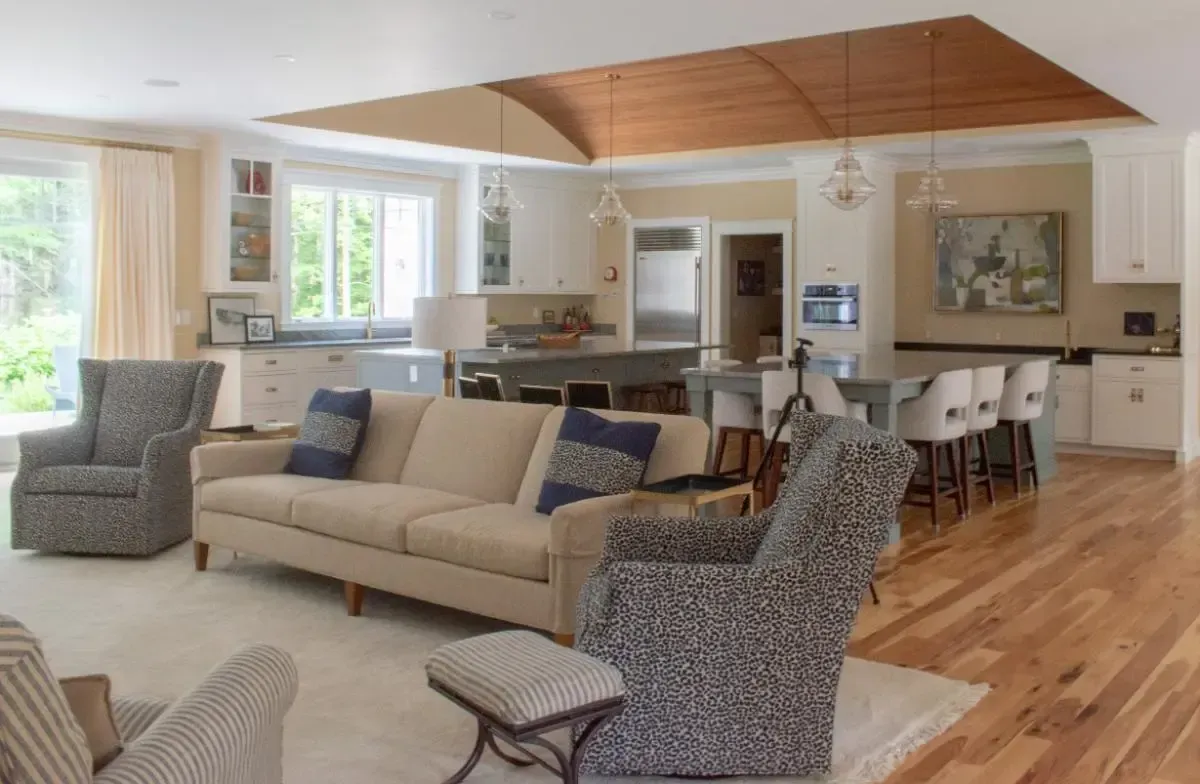 Living room with two chairs and a view into the kitchen