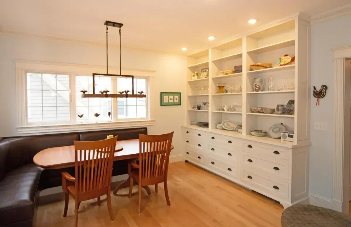 Dining room with built-in shelving and a wood table