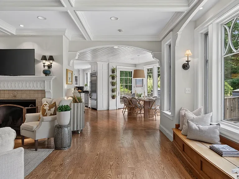 Formal living space with tailored millwork and a view into adjoining rooms