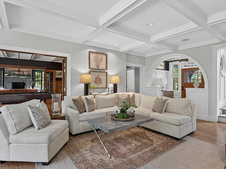 Fireplace sitting room with custom shelving and detailed ceiling trim